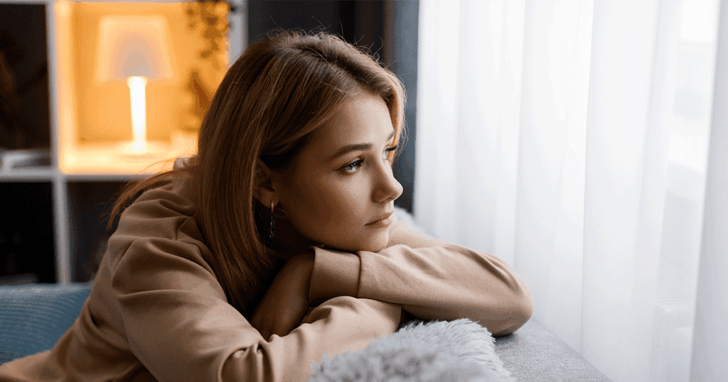 Mother sitting alone while worrying about her fussy baby