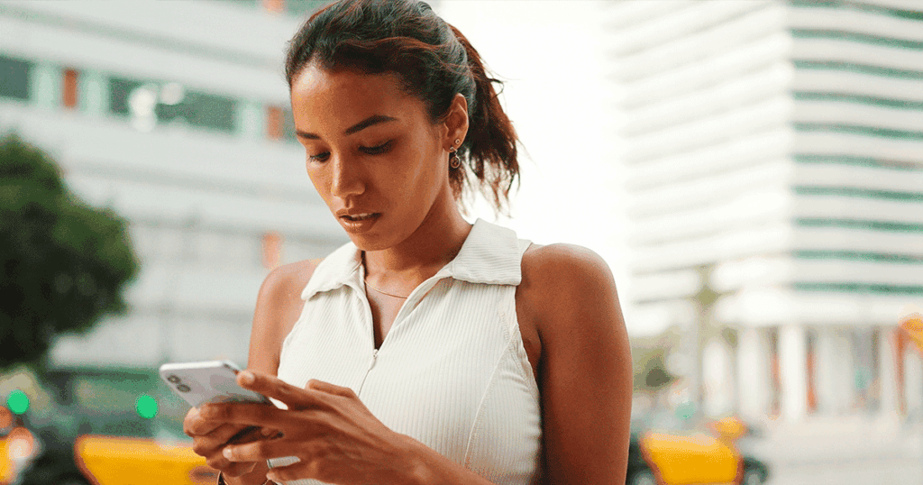 Woman beginning her post-abortion healing journey while looking at her phone.
