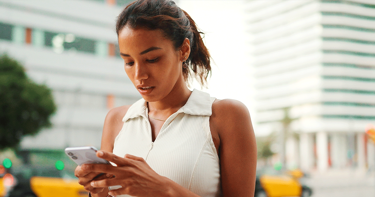 Woman beginning her post-abortion healing journey while looking at her phone.